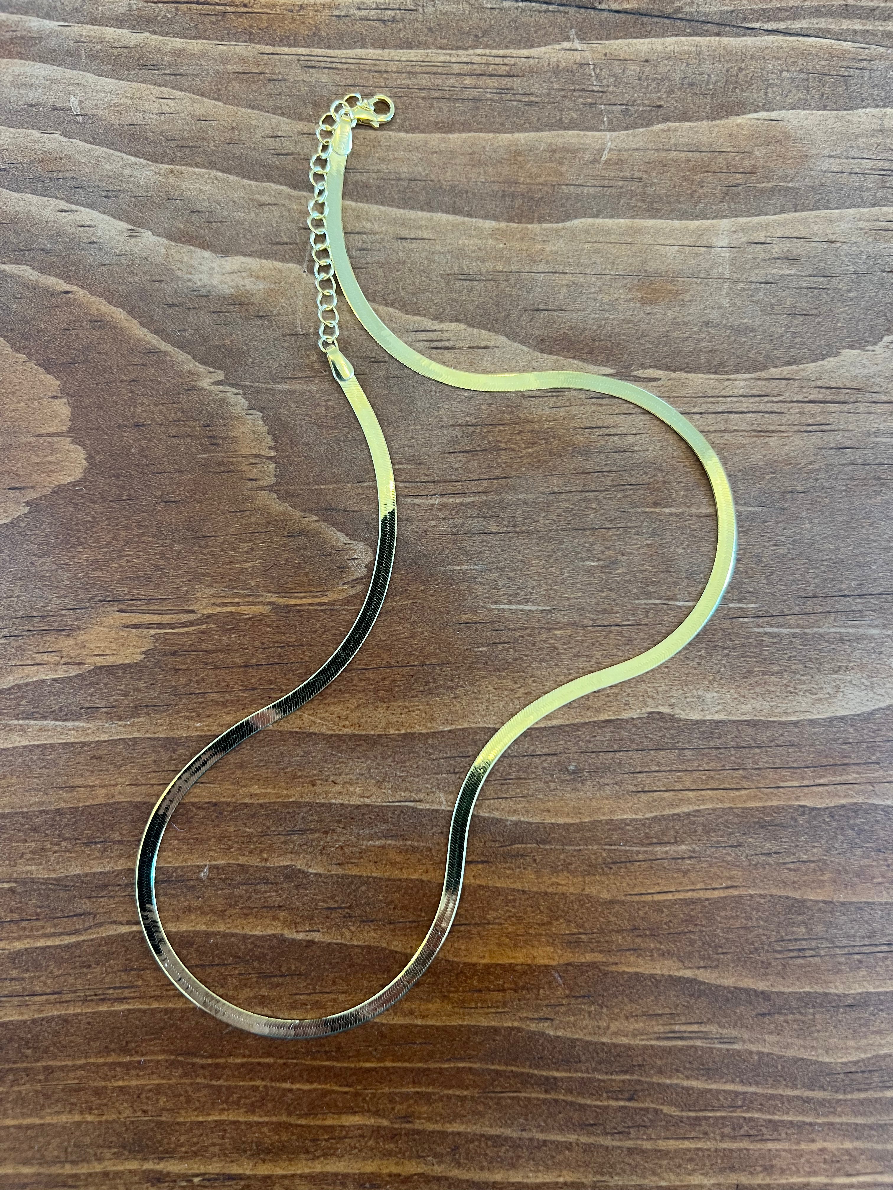 high polish 10k solid gold high quality herringbone shape gives a slinky, sexy reflection sturdy and durable lobster clasp 16” with extender to 18” lengths available ; 2.5mm wide herringbone