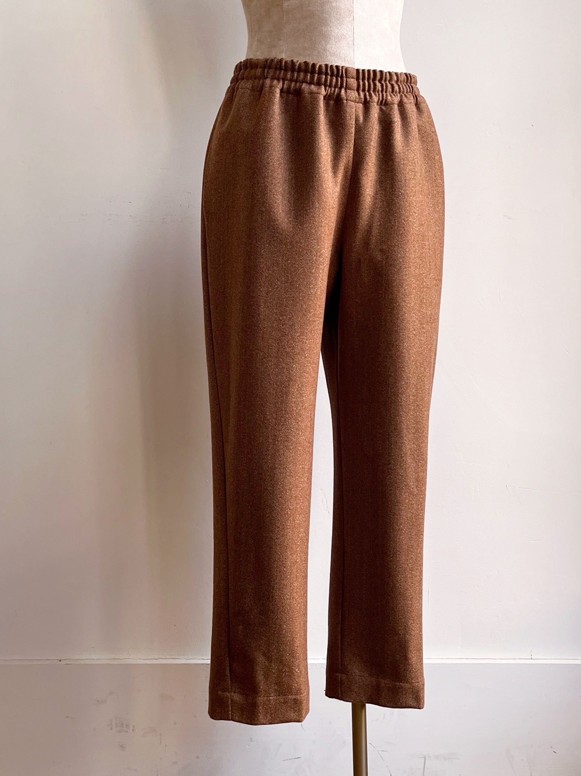 Image of caramel herringbone wool jogger-style pants on mannequin