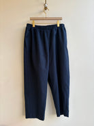 Image of cropped jogger-style pants in navy blue cotton canvas