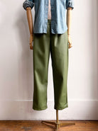 Image of green faux leather jogger-style pants on mannequin